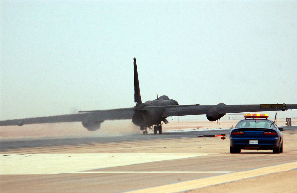 A chase car races down the runway behind a landing U-2 the types signature ritual.