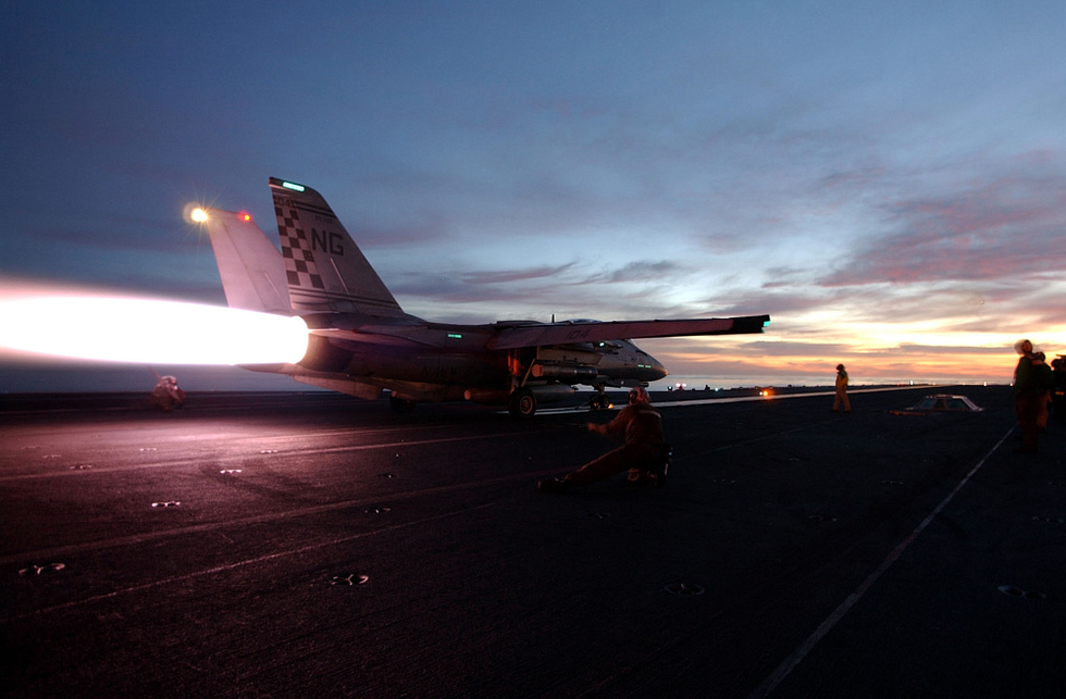 An F-14 Tomcat in full afterburner two turbofans lit.