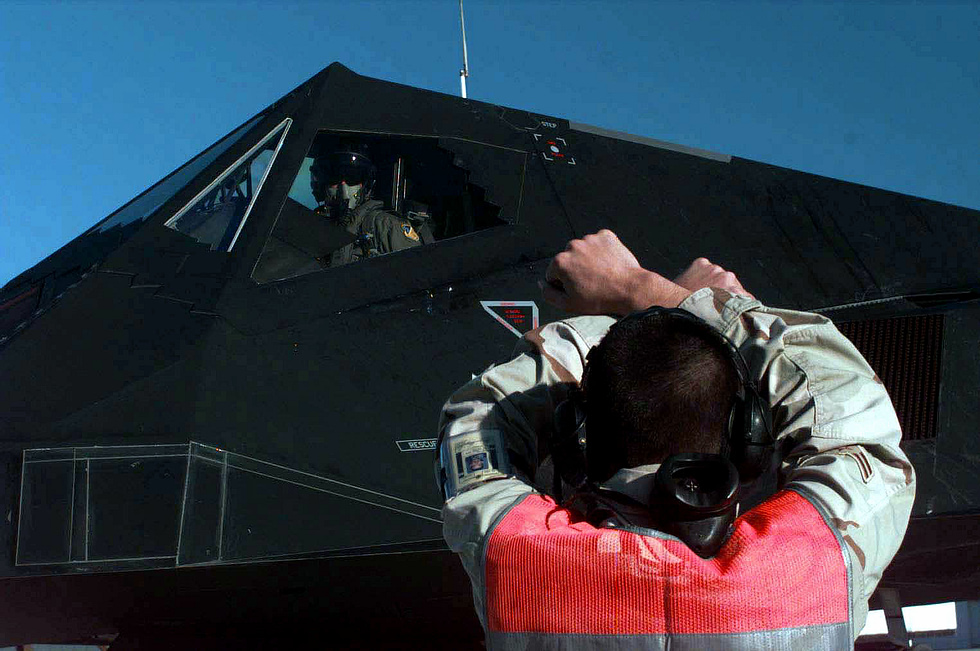 Ground crew marshals a Nighthawk deploying to the Persian Gulf in 1998 the jet flew and fought only at night.