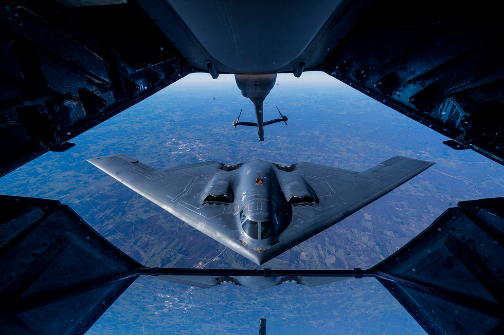 A B-2 taking on fuel in flight a single top-up extends its reach to around 10,000 nautical miles.