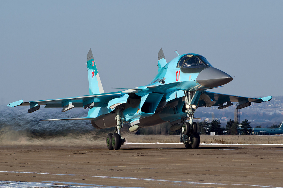 A Russian Air Force Su-34 banking away, its twin tails and long tail sting visible.