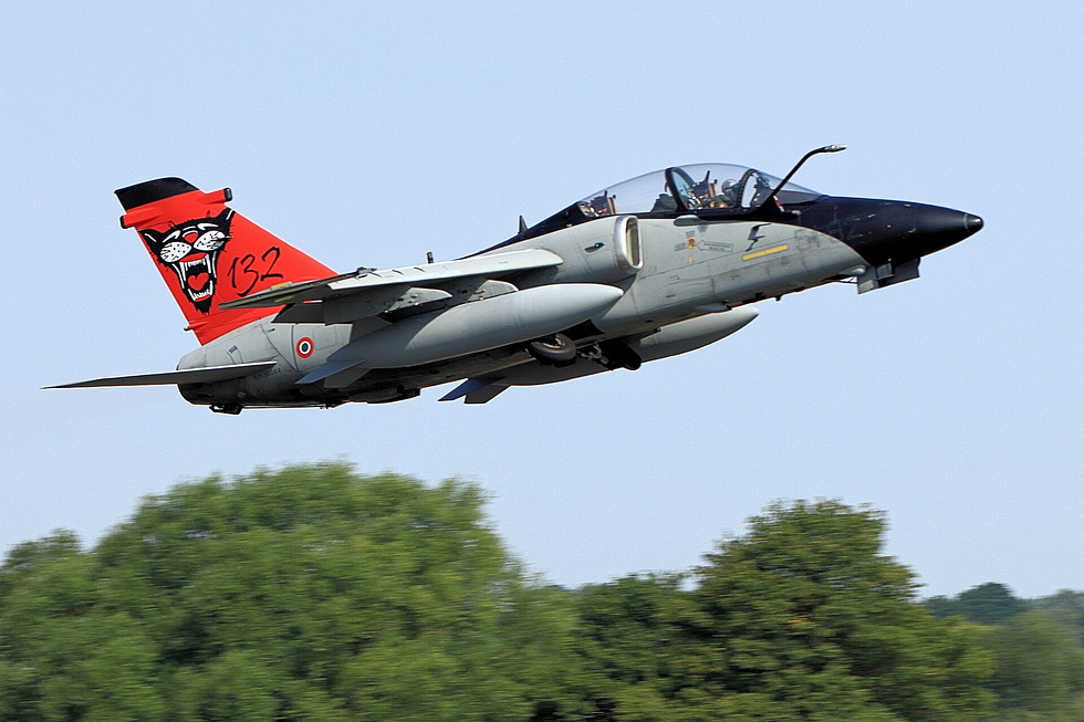An Italian AMX banks away, showing the clean planform of its high-mounted wing.