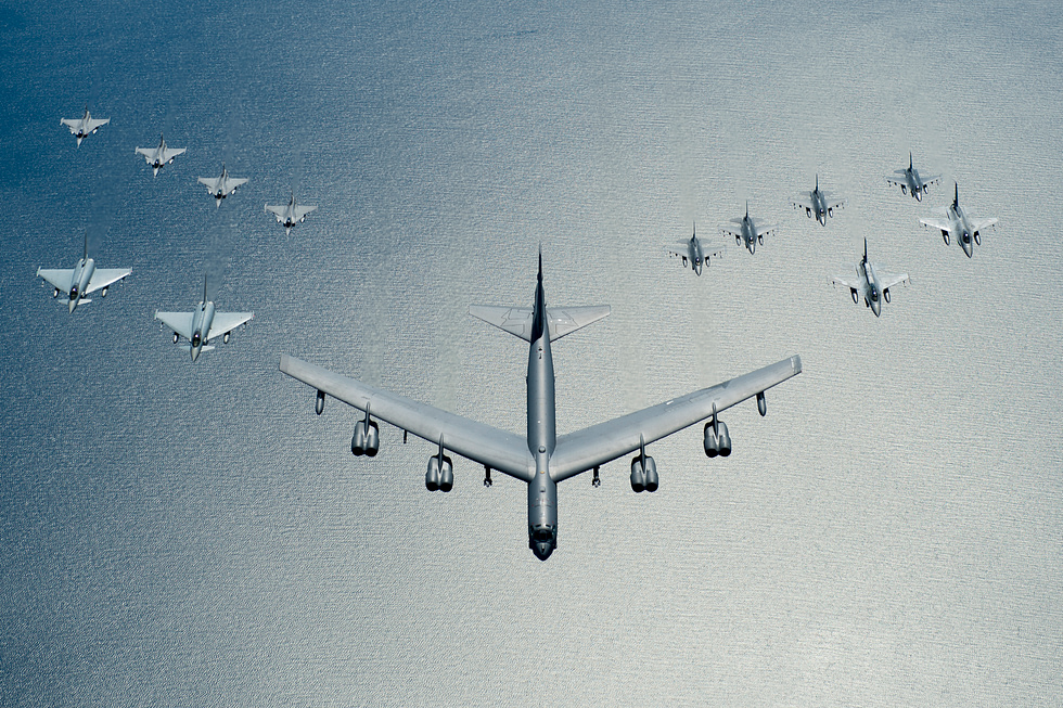 A B-52 leads a formation over the Baltic Sea a deterrence patrol with allied jets.