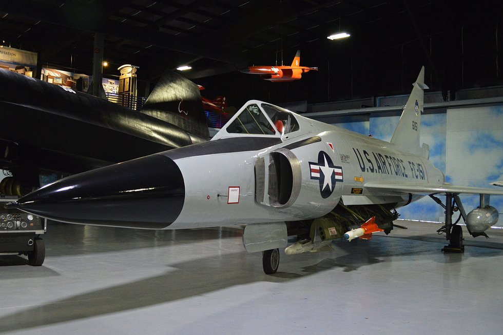 A preserved F-102A in profile the pinched coke-bottle area-rule fuselage is clearly visible.