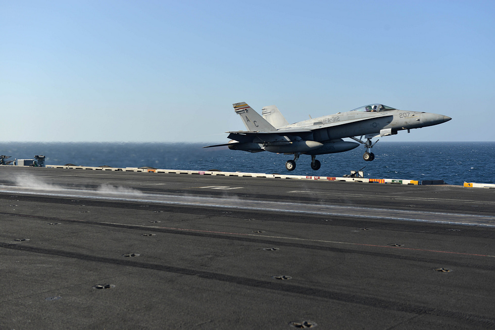 A US Marine Corps F/A-18C Hornet fires off the catapult of USS Harry S. Truman the violent carrier launch the airframe was reinforced for.