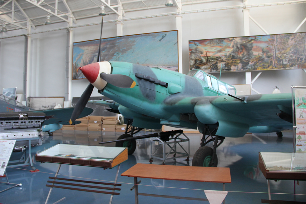 A preserved two-seat Il-2 in three-quarter view, its long stepped canopy covering pilot and rear gunner.