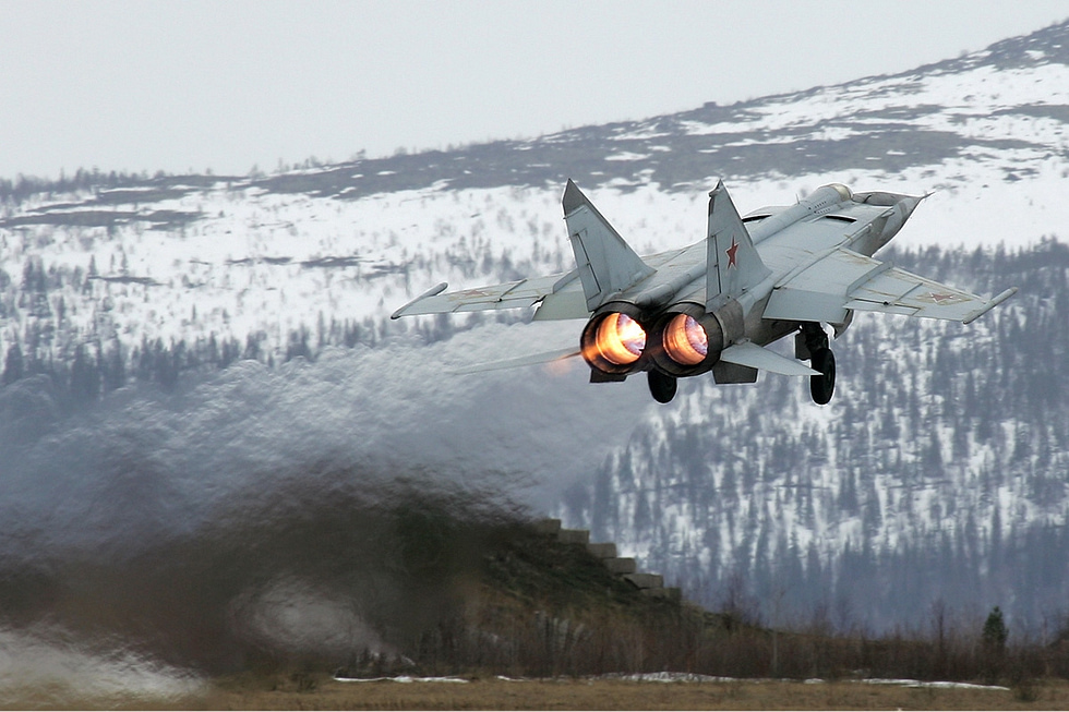 MiG-25RB Foxbat taking off on afterburner over snowy mountains