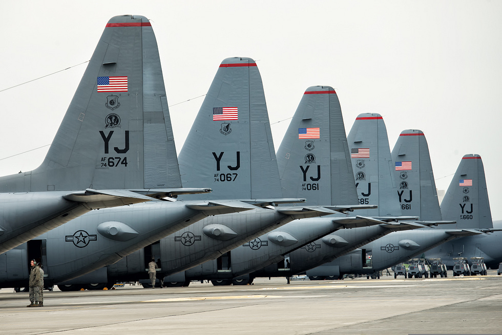 A line of U.S. Air Force C-130 Hercules on the flight line at Yokota Air Base before a large-formation flight.