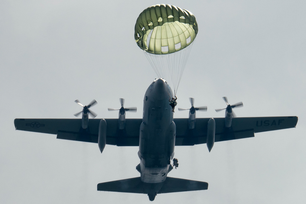 Paratroopers jump from a C-130 Hercules the airborne assault role the aircraft was designed for.