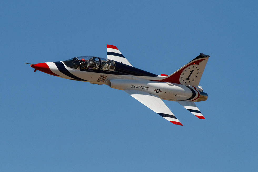 A Talon banks at an air show the area-ruled fuselage and thin wing on show.