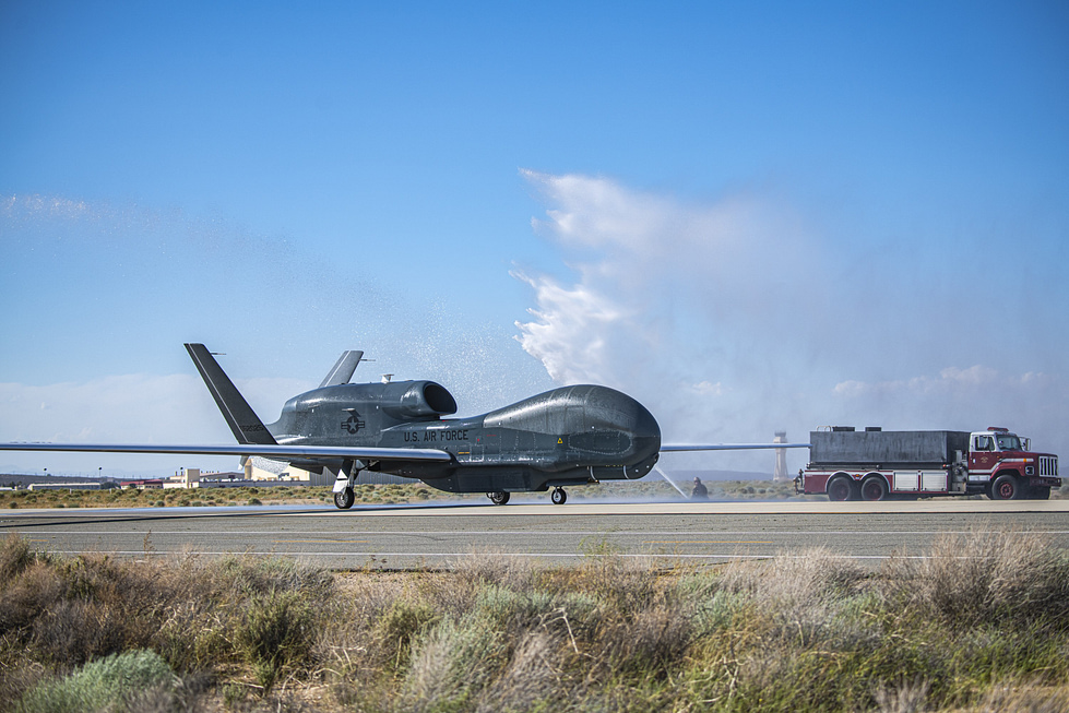 Fire trucks give an RQ-4 Global Hawk a ceremonial water salute at Edwards Air Force Base.