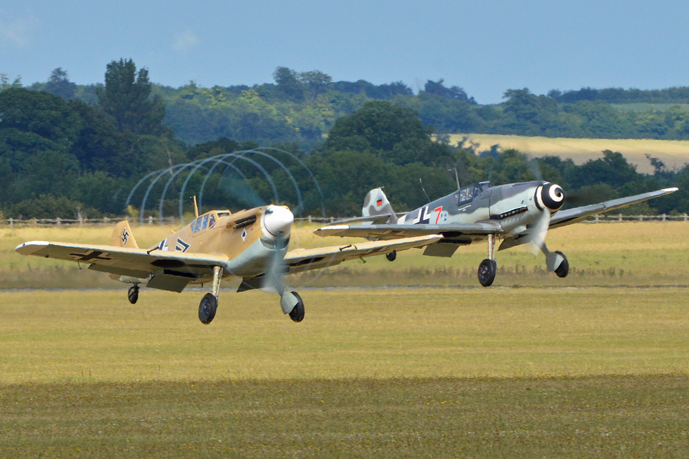 Airworthy Messerschmitt Bf 109 warbirds flying at an air show.