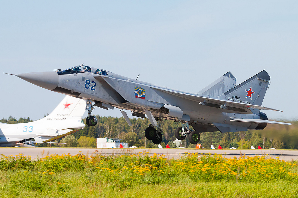 A MiG-31 Foxhound rotating off the runway two D-30F6 turbofans in full reheat.