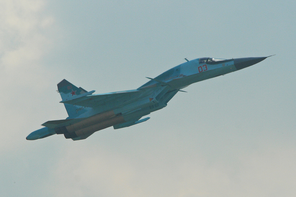 A Su-34 flypast showing the broad duckbill nose that houses the two-seat cockpit.