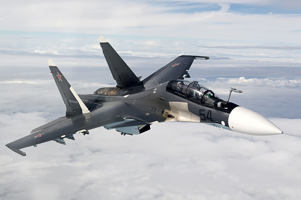 A Russian Air Force Su-30SM banking in flight the two-seat, thrust-vectoring Flanker.