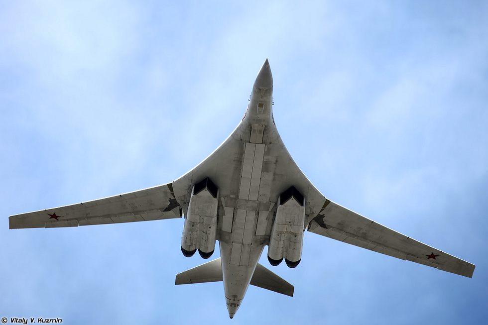 A Tu-160 in its white anti-flash finish over Moscow the White Swan.