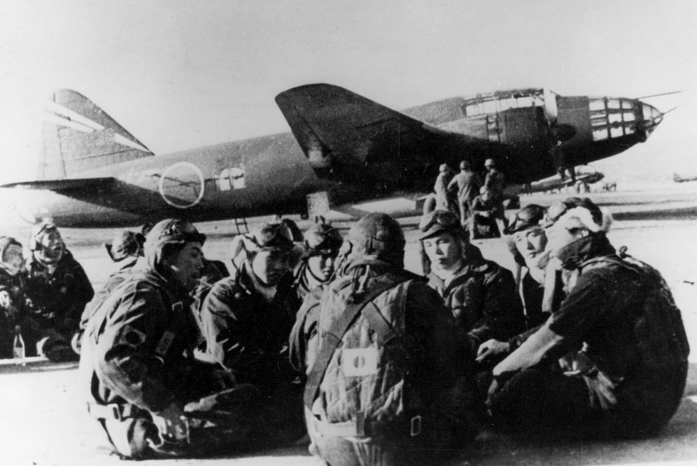 Standby aircrews rest before a G4M2e carrying a Yokosuka MXY-7 Ohka piloted rocket bomb, 1945.