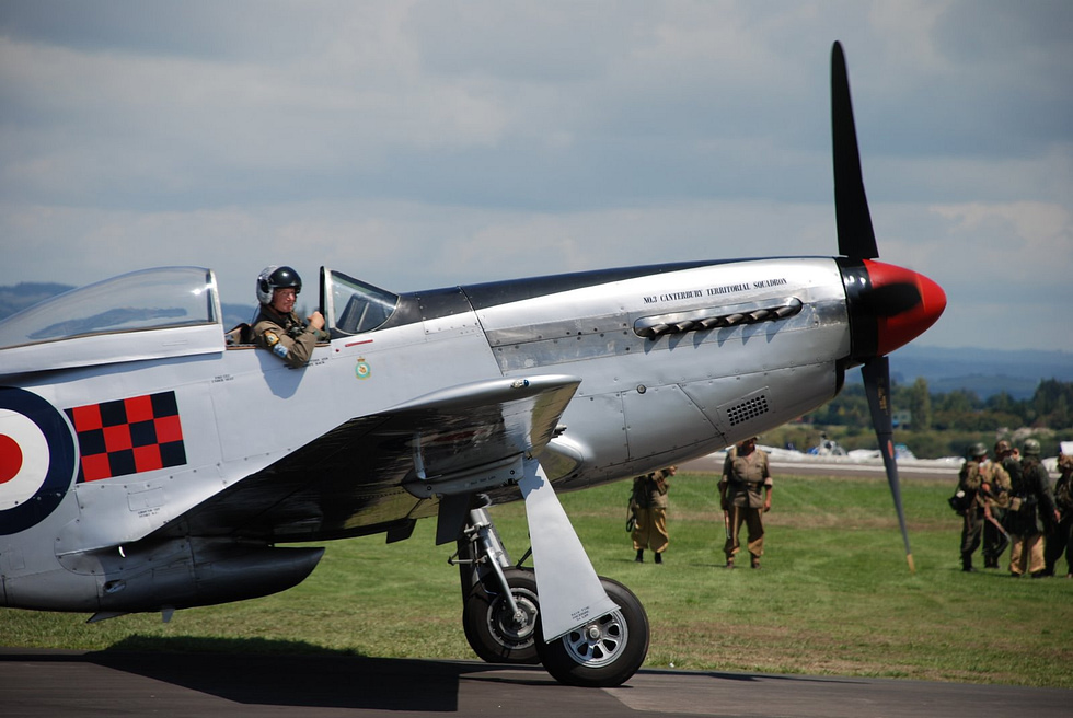 A preserved P-51D Mustang warbird in classic bare-metal finish the type most people picture as a WWII fighter.
