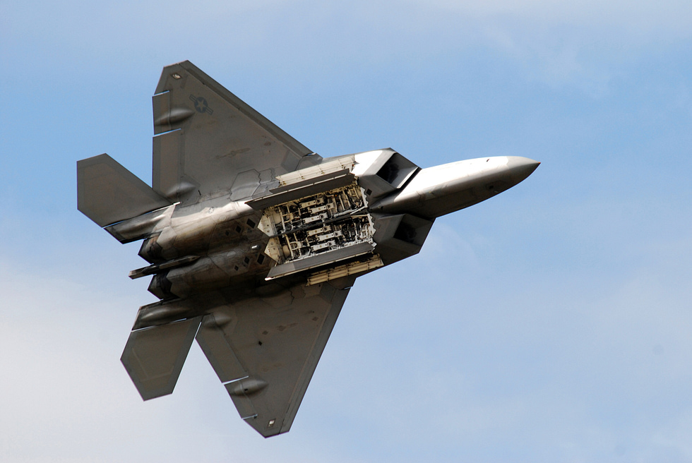 An F-22 opens a side weapon bay in flight all weapons are carried internally to stay stealthy.