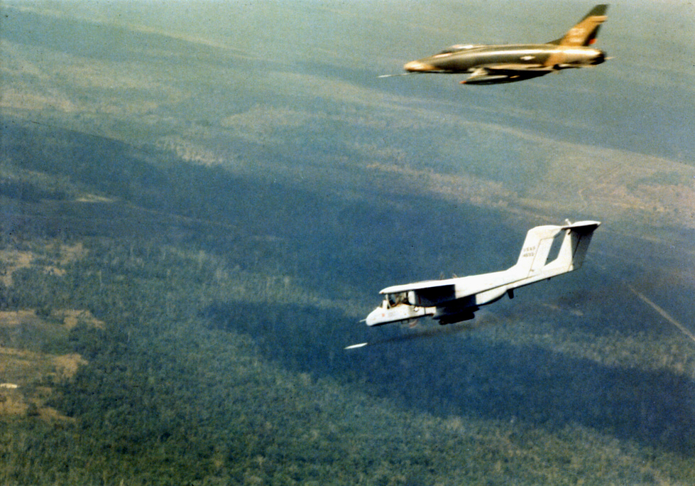 An OV-10A marks a ground target with smoke for a strike aircraft over Vietnam, 1969 the classic forward-air-control mission.