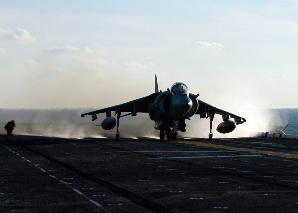 A US Marine Corps AV-8B Harrier launching from the deck of USS Kearsarge.