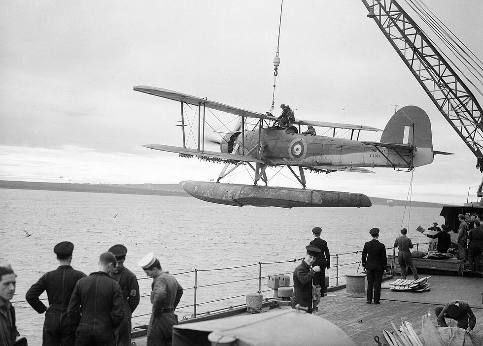 A Swordfish being hoisted aboard the battleship HMS Malaya.