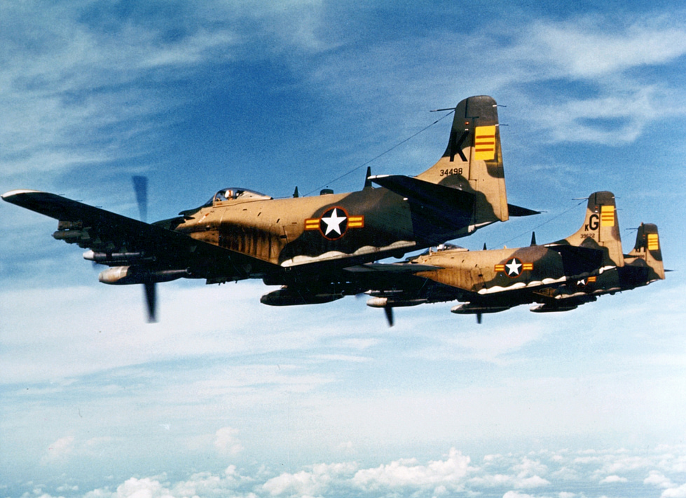 A Skyraider in South Vietnamese markings, armed and in flight the flying dump truck at work.