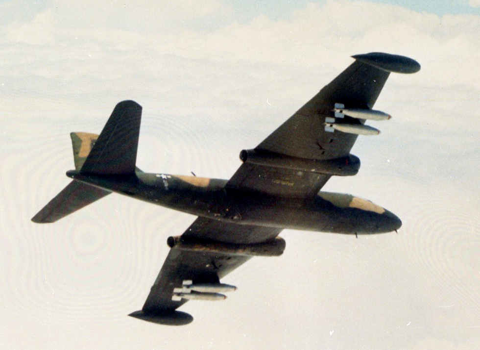 A Martin B-57B Canberra of the 8th Bomb Squadron carrying napalm tanks over Vietnam, 1969.