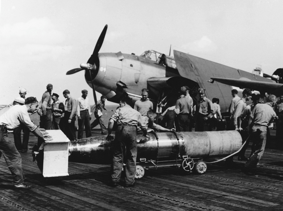 Ground crew load a Mark 13 aerial torpedo into an Avengers internal bay aboard USS Wasp.
