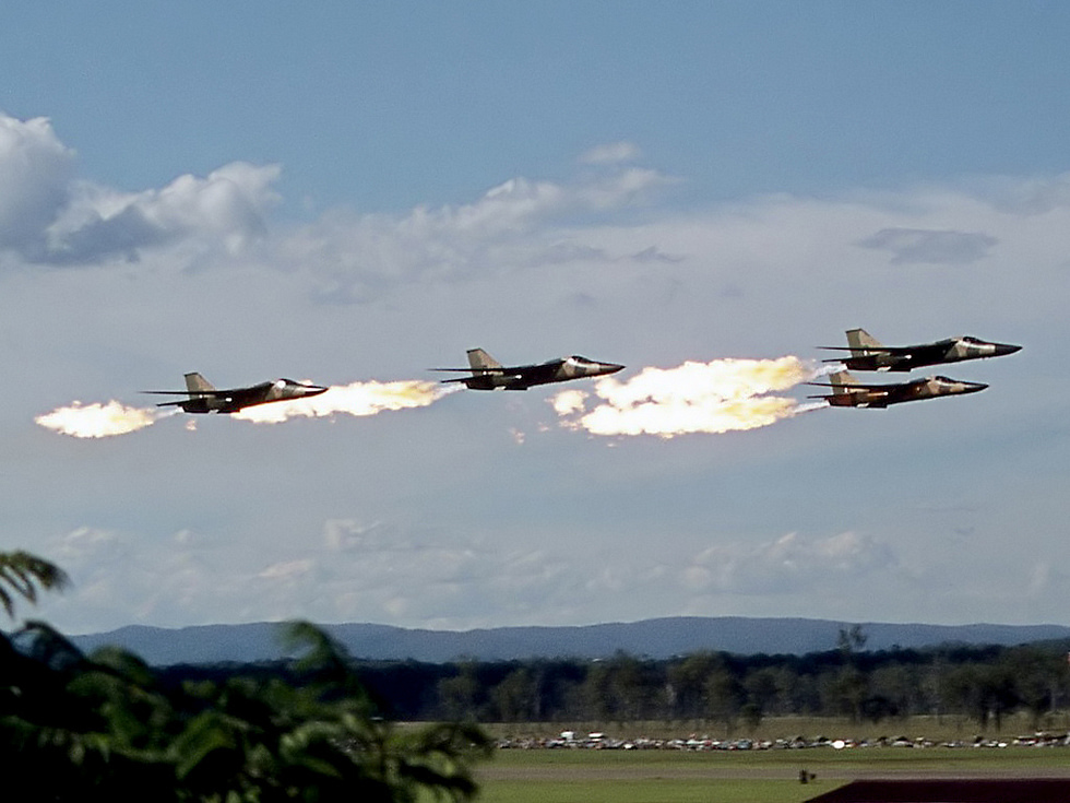 A RAAF F-111C performs the famous dump and burn fuel ignited behind the afterburners.