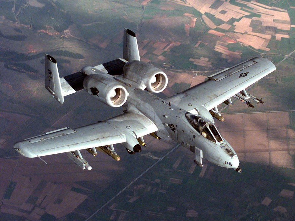 An armed A-10 Thunderbolt II carrying ordnance in flight.