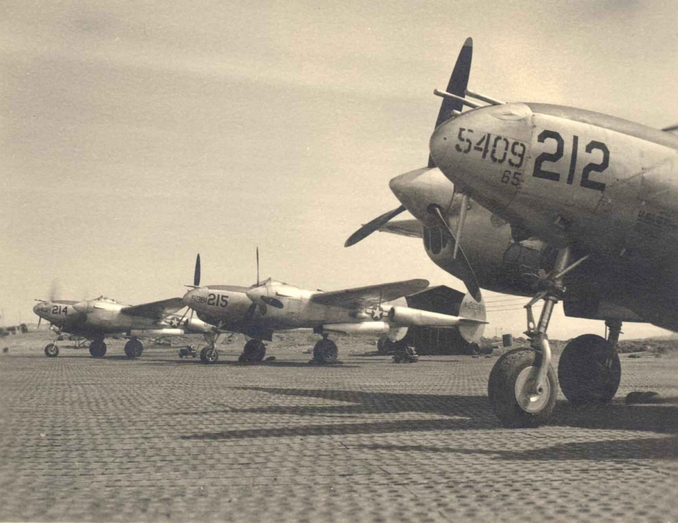 P-38 Lightnings on the flight line the fighter that stayed in production all war.