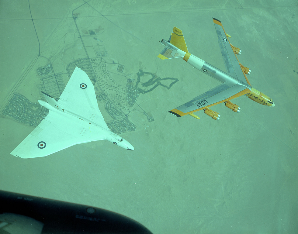 A Vulcan formates with a US B-52 Stratofortress Britains delta beside Americas heavy.