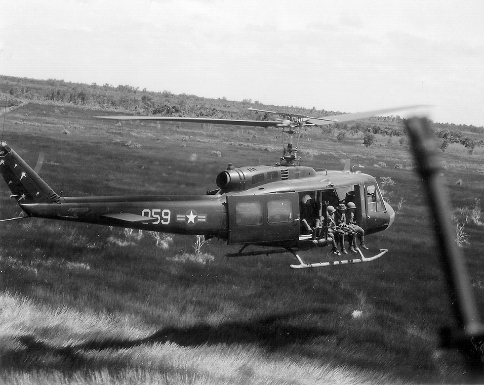A UH-1 Iroquois Huey in flight during the Vietnam era the aircraft that defined air mobility.