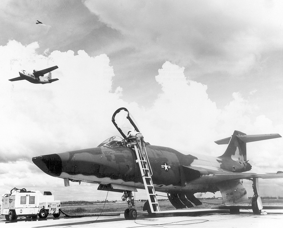 Technicians prepare an RF-101 Voodoo on the flight line the camera-nosed Long Bird reconnaissance jet.