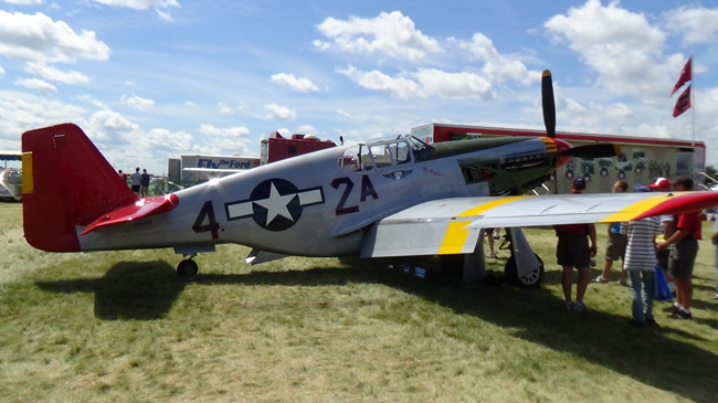A red-tailed P-51 in Tuskegee Airmen markings the 332nd Fighter Groups distinctive escort livery.