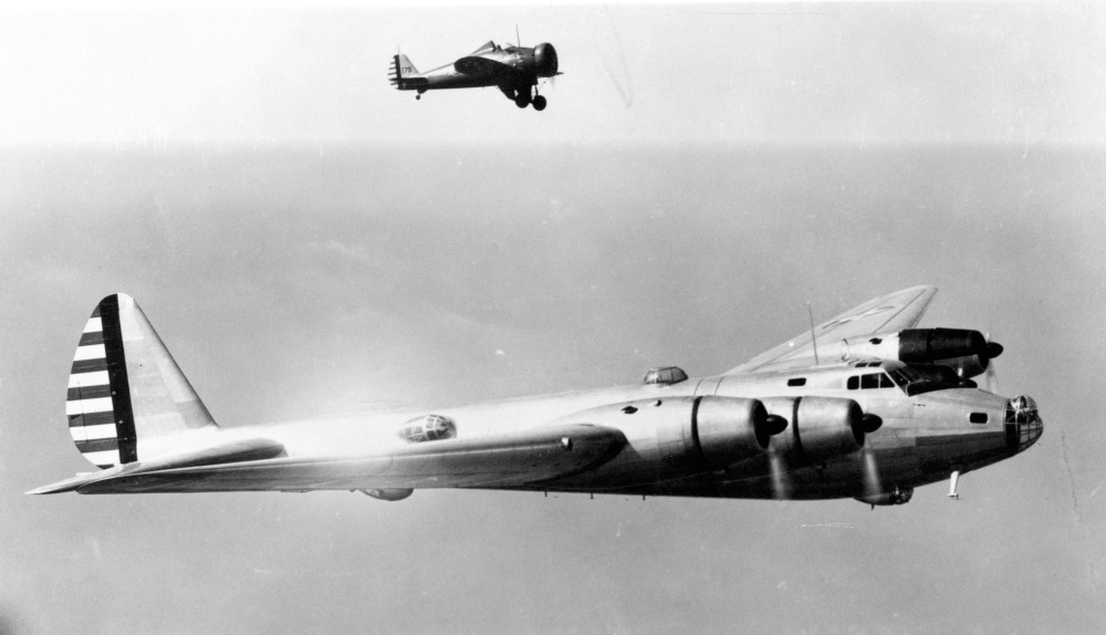 A Boeing P-26 dwarfed beside the huge Boeing XB-15 experimental bomber