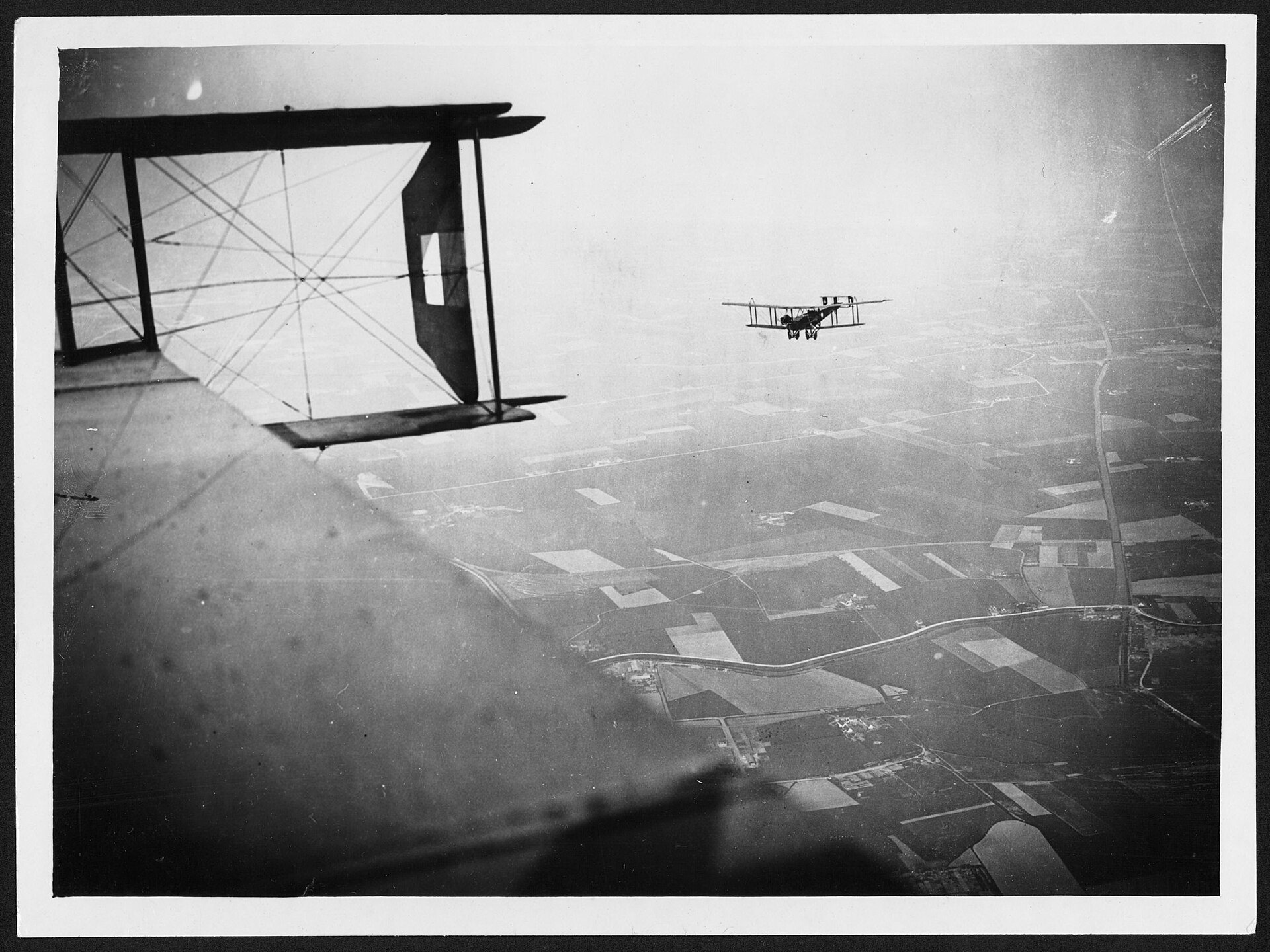 Handley-Page bombers on a mission over the Western Front, one making for the enemy lines.