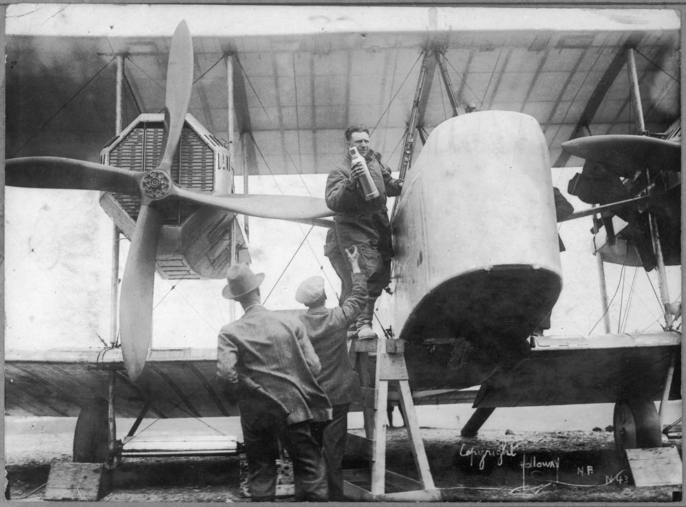 Captain John Alcock stowing provisions aboard the Vickers Vimy, Newfoundland, June 1919