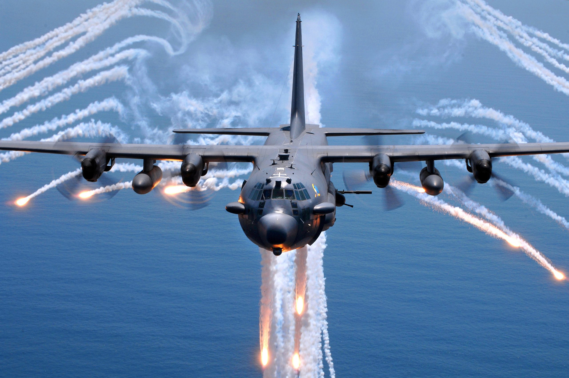 Lockheed AC-130 gunship dispensing defensive flares in flight
