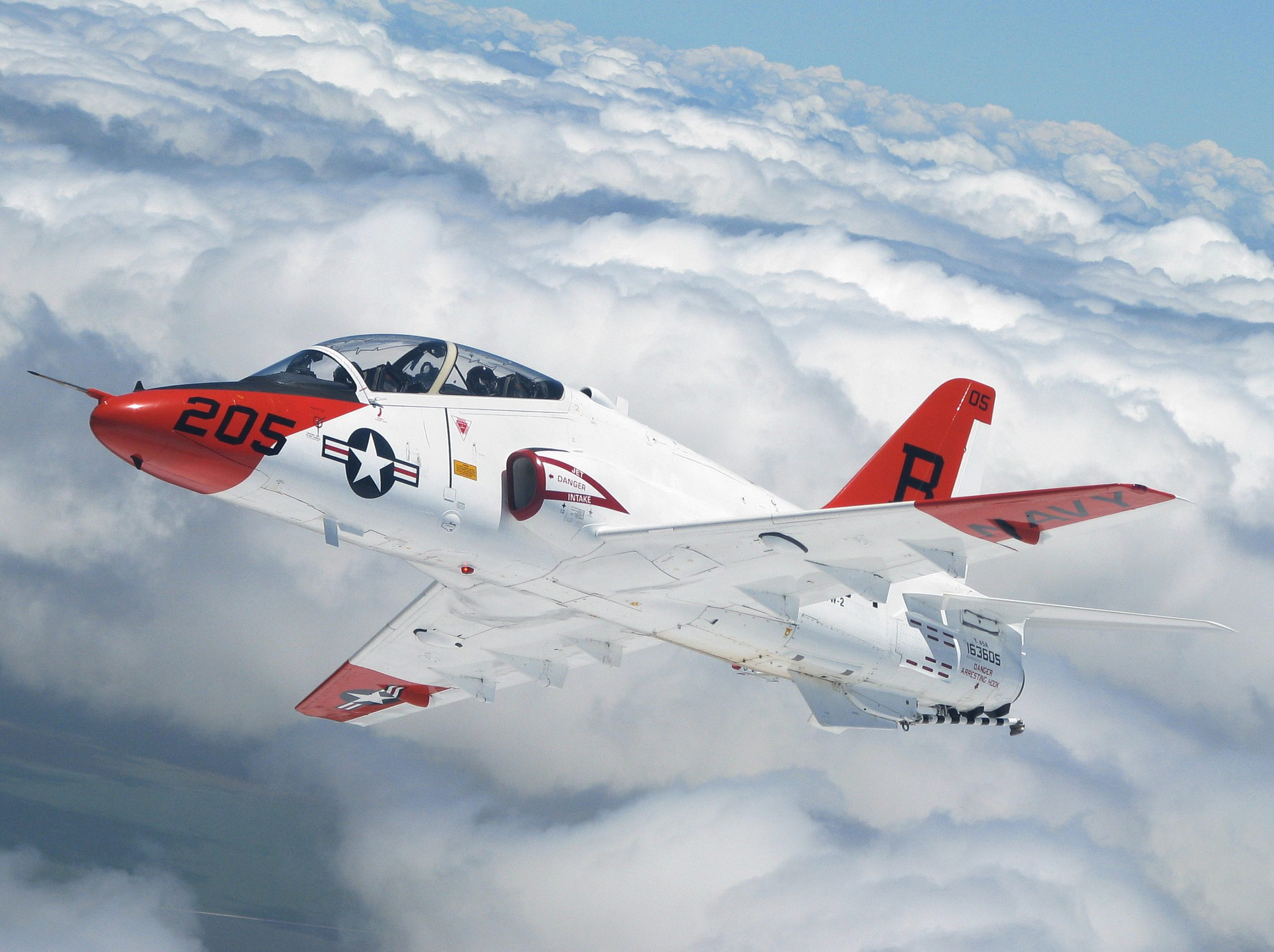 A U.S. Navy McDonnell Douglas T-45 Goshawk jet trainer banking in a formation turn