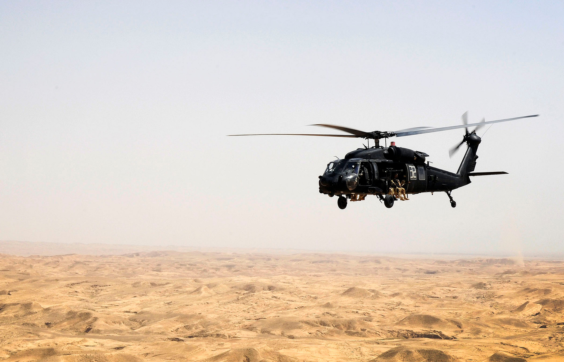 MH-60L Black Hawk over desert terrain in Iraq