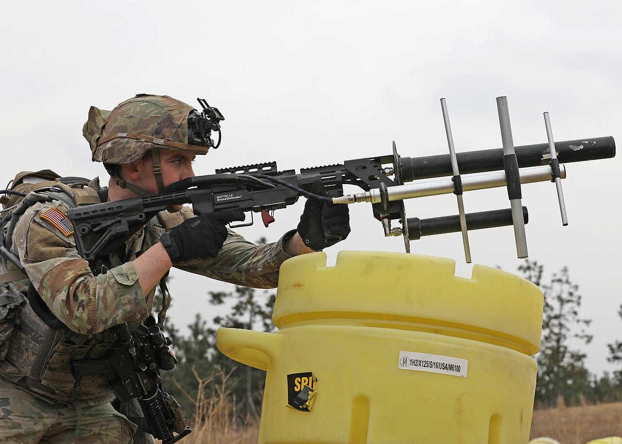 A soldier using a counter-drone (C-UAS) system