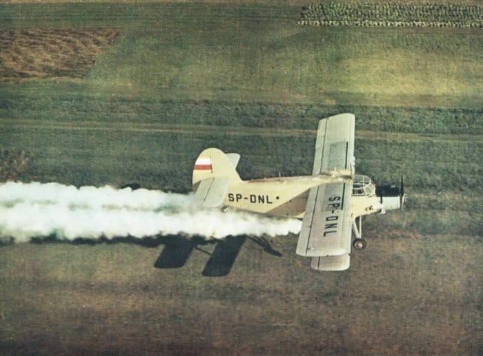 Antonov An-2R agricultural aircraft spraying a field