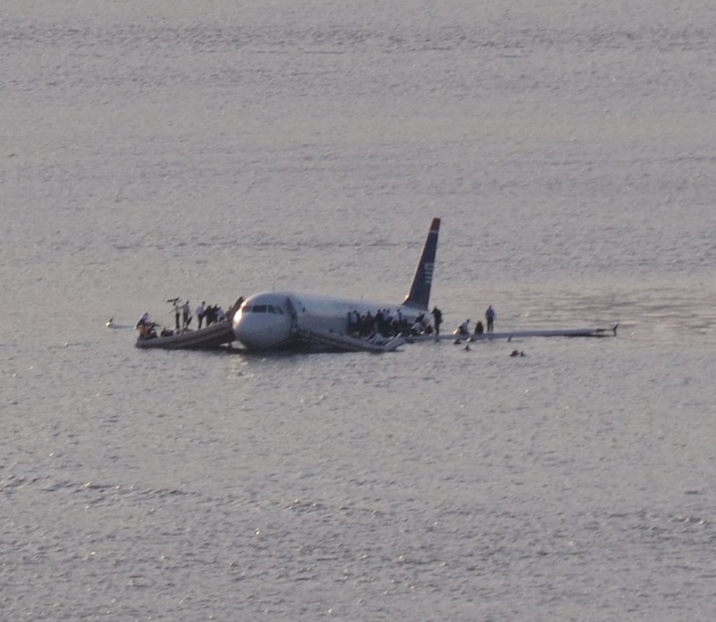 Passengers standing on the wings of US Airways Flight 1549 in the Hudson River