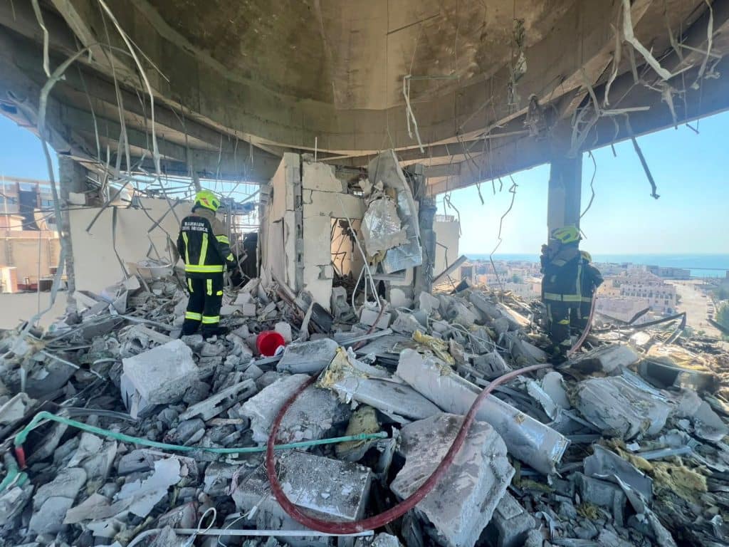 Bahraini civil defence in damaged Muharraq building