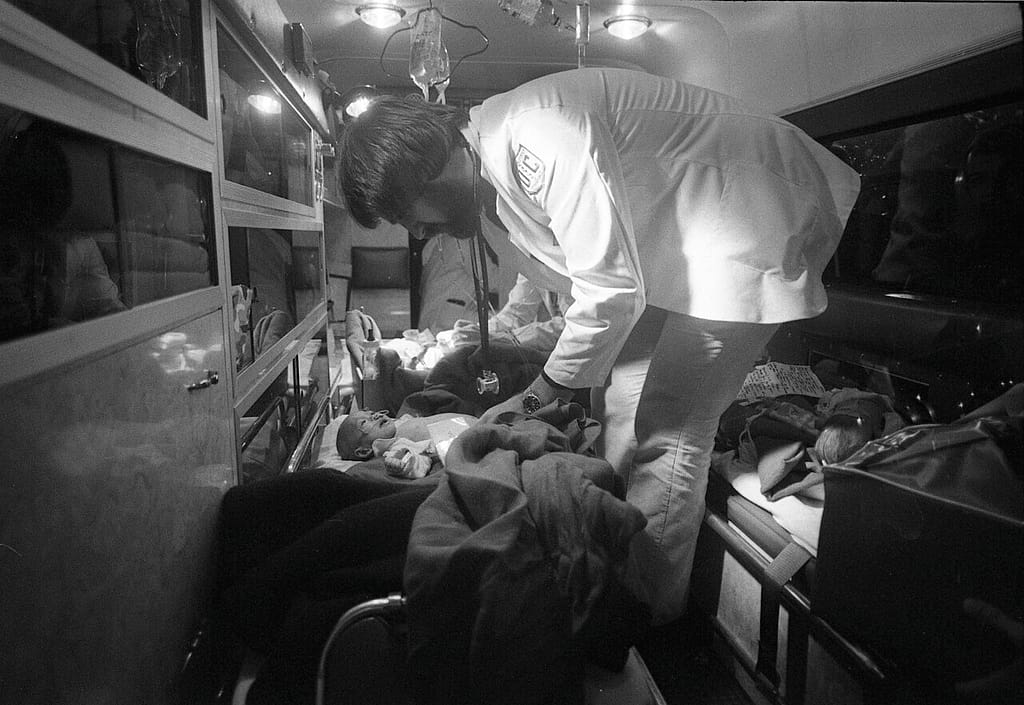 Medical staff examining Vietnamese children after an Operation Babylift flight arrival, 1975