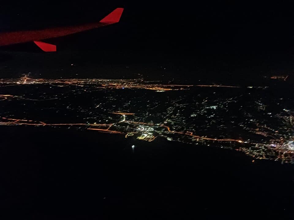 night-flying-left-seat Night flying aerial view of city lights from aircraft cockpit