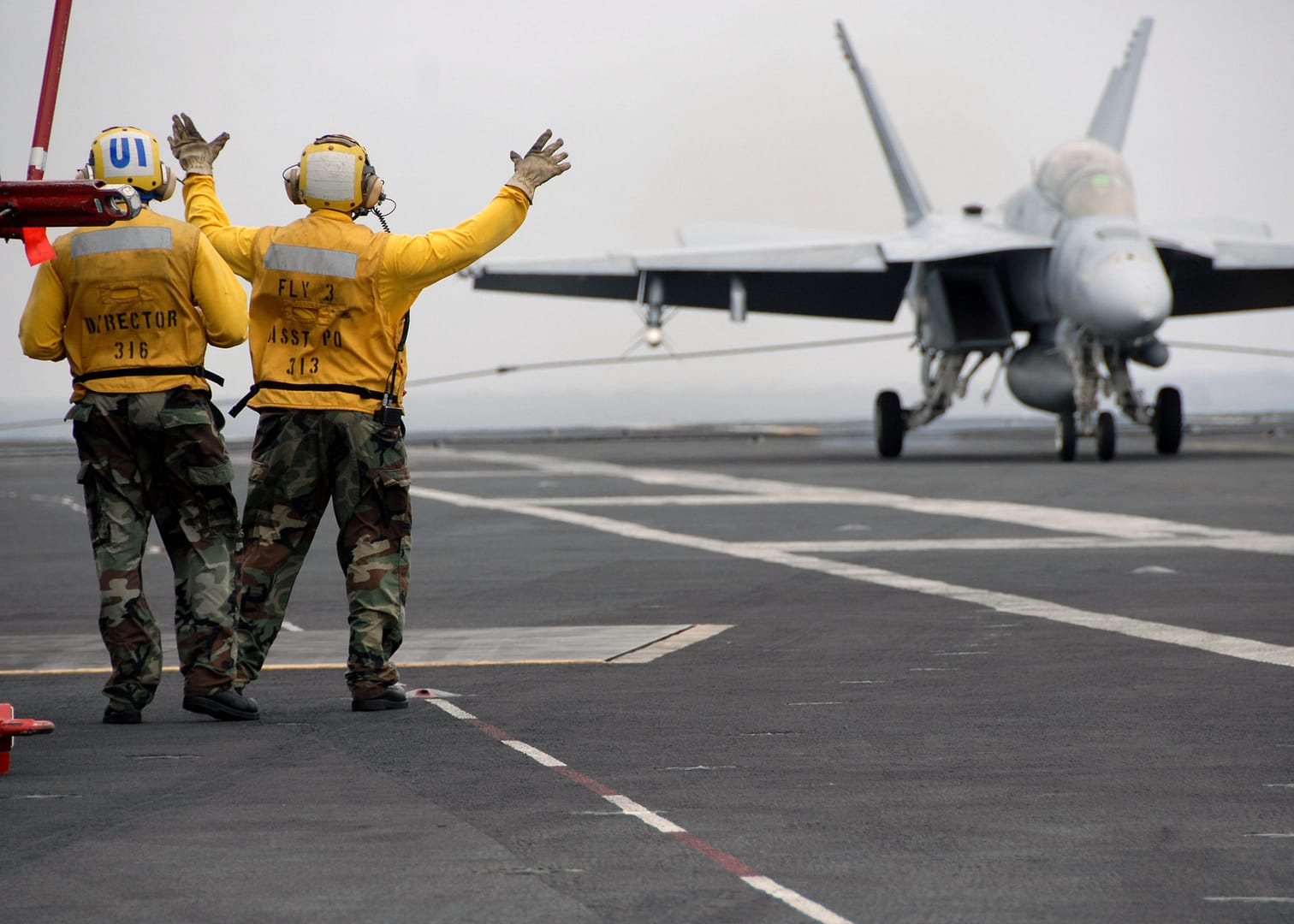 F/A-18 Super Hornet making an arrested landing on an aircraft carrier