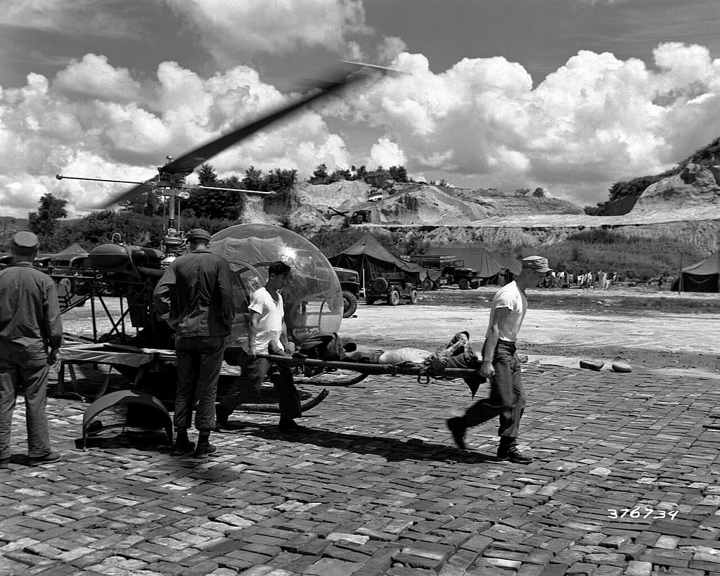 A wounded soldier being taken from an H-13 helicopter in Korea, 1951